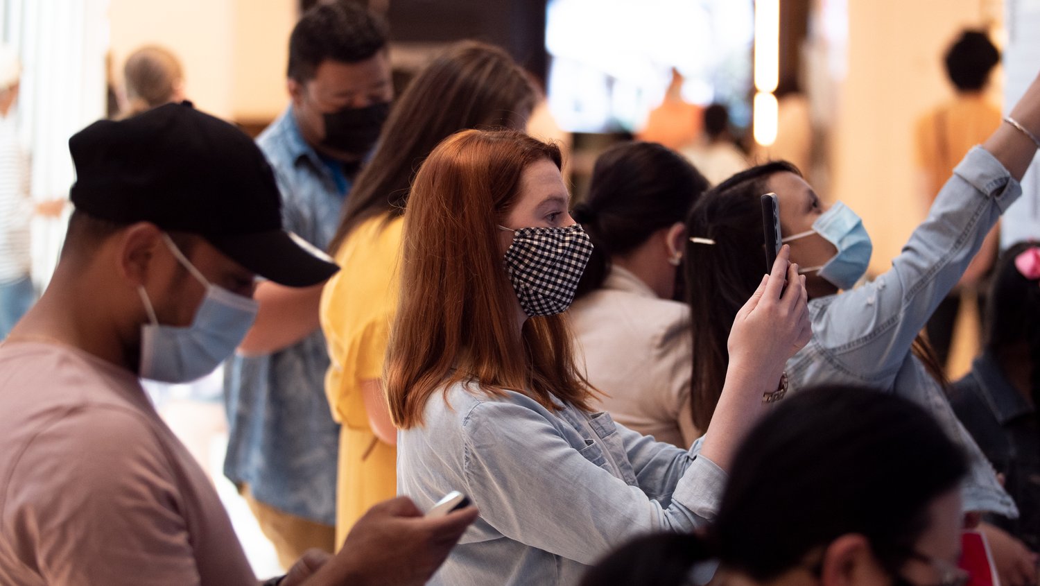 Shoppers interacting with a Sydney based experiential piece for Samsung featuring a mosaic of scannable QR codes that come together to say 'Expand our World'