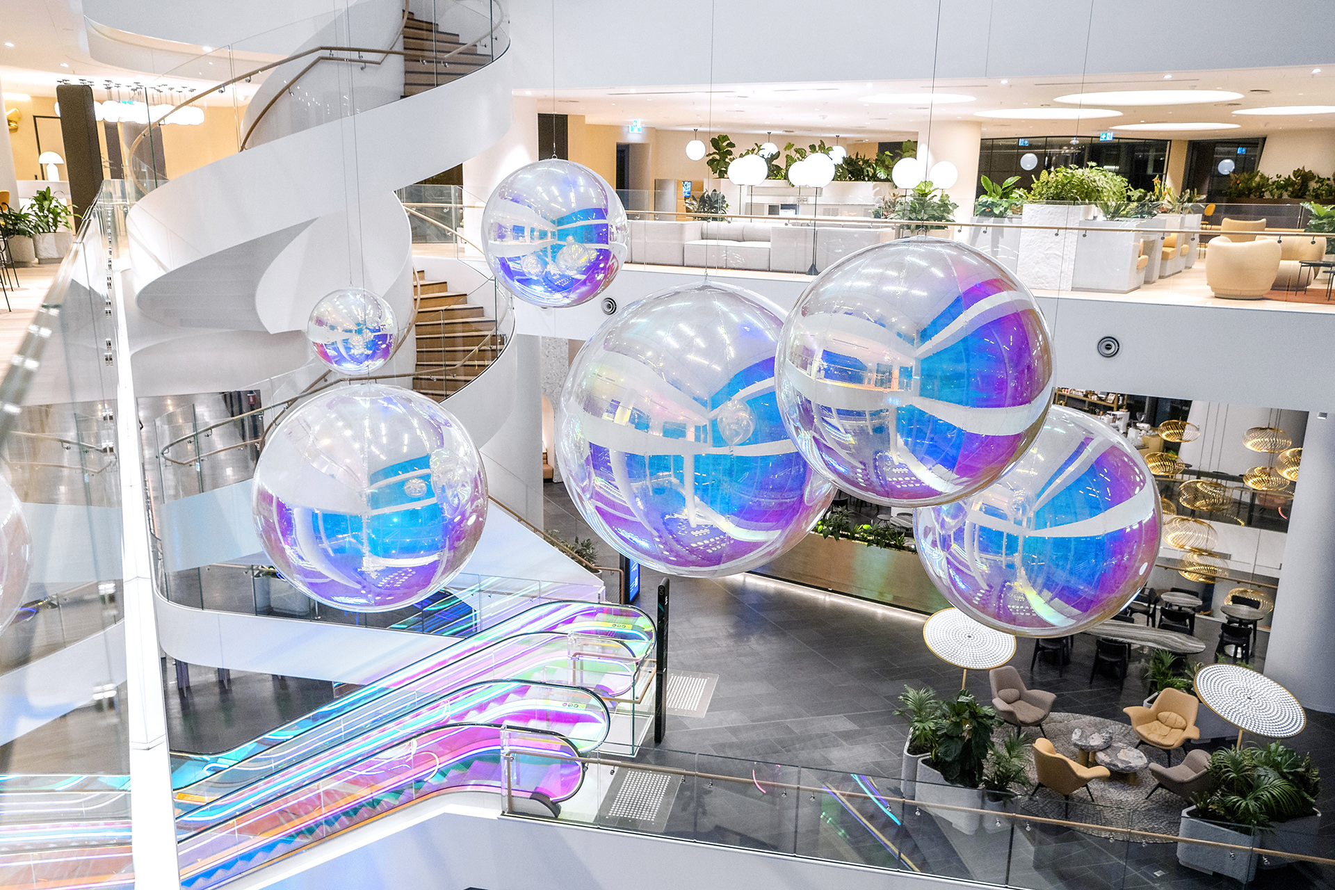VANDAL Experiential Christmas Campaign for Dexus in the commercial lobby of 50 Bridge Street, Sydney showing dichroic film on escalators and artistic sculpture Christmas tree.