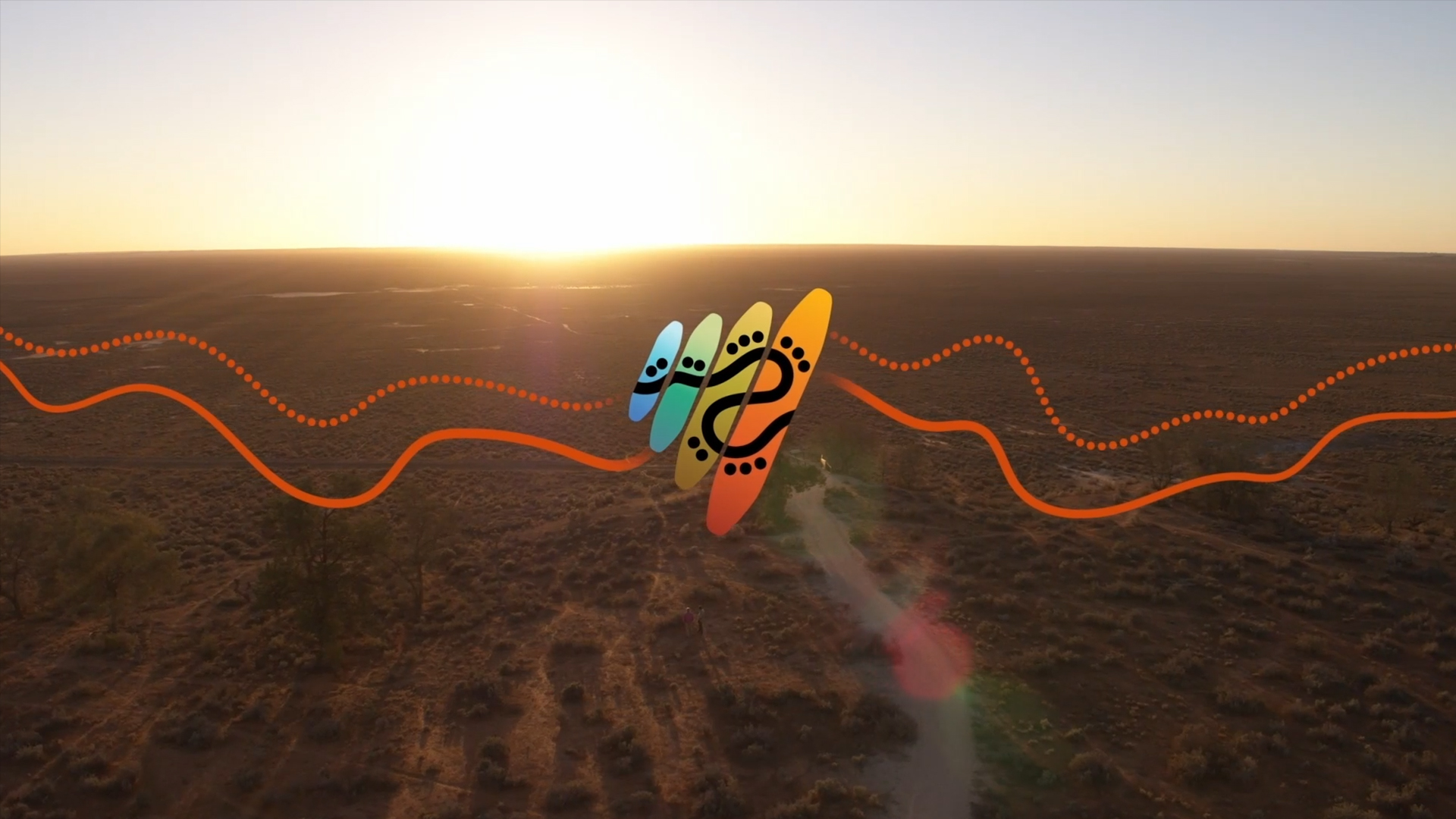 Bilma, or clapstick, logo for NITV's rebrand created by VANDAL in conjunction with First Nations creative agency Gilimbaa - TVC still featuring the new logo overlaid on desert sand using motion graphics