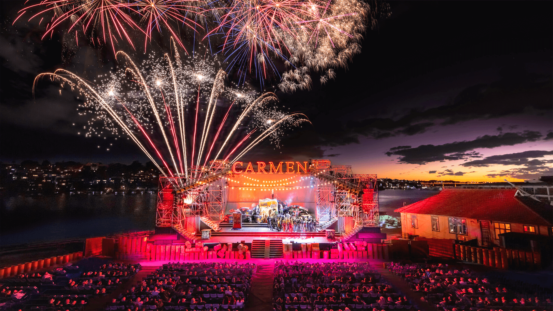 The stage of Carmen on Cockatoo Island flanked by fireworks featuring graphics by VANDAL