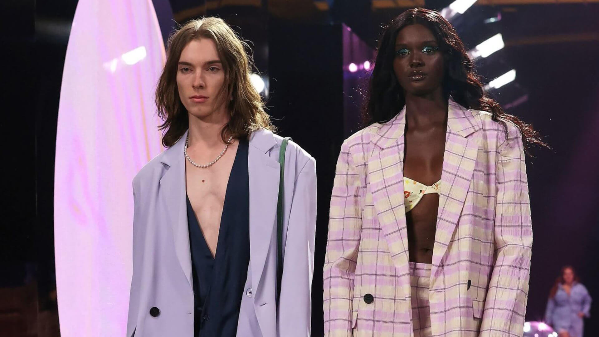 Close-up of male and female models walking on fashion runway for The Iconic RUNWAY X fashion show.