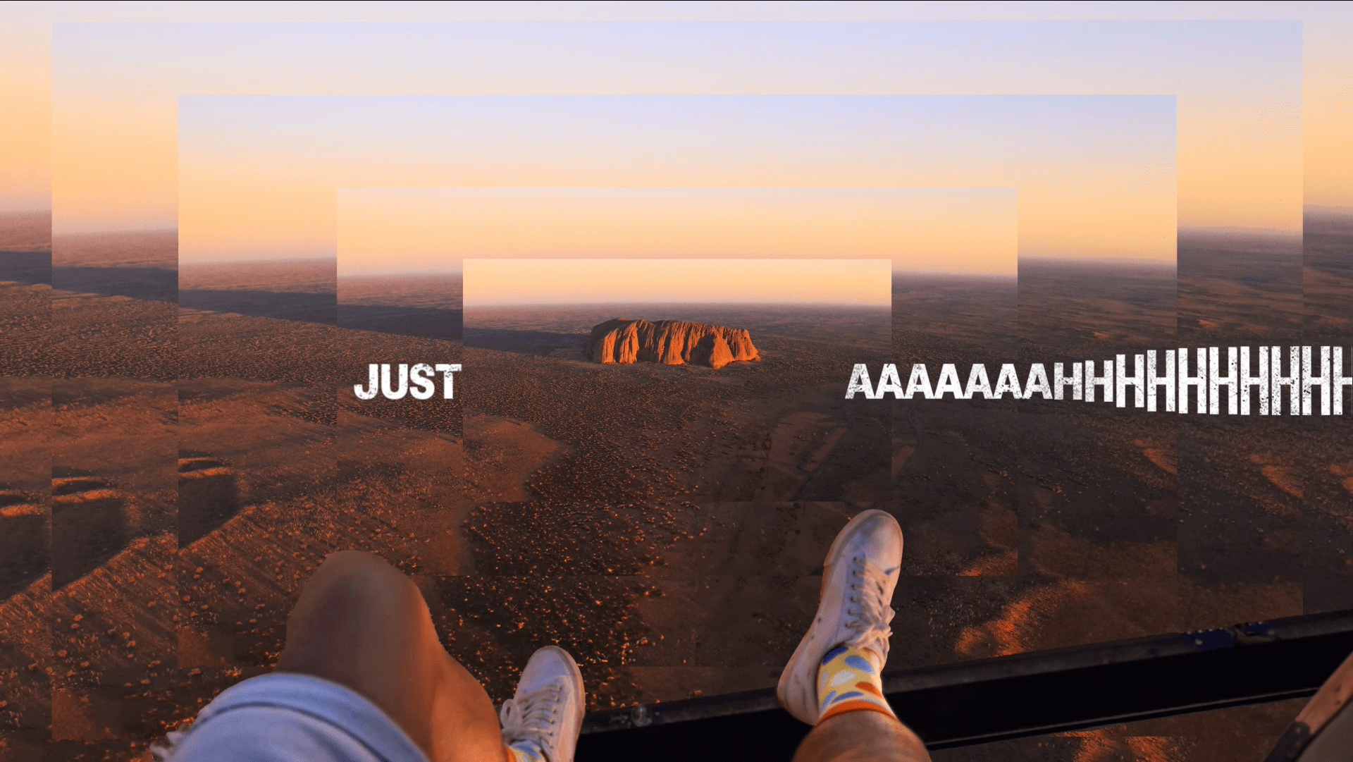 Voyages 'Just Wow' Uluru Ayers Rock Resort campaign featuring a first person high shot of Uluru with their feet dangling in the shot