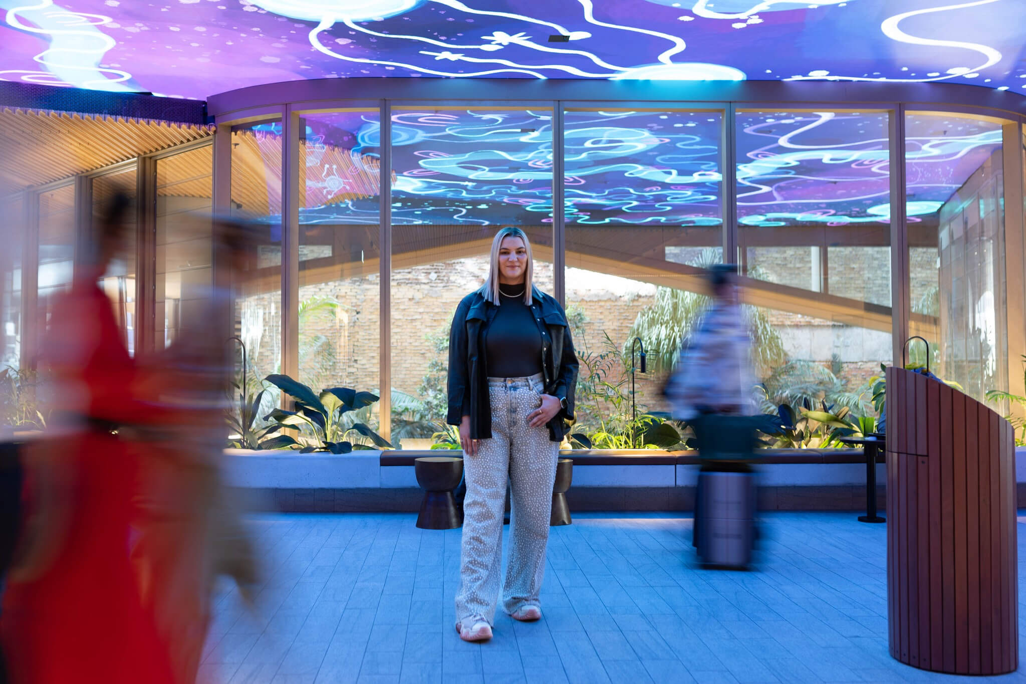 Photo of artist Rachael Sara Mirvac Heritage Lanes commercial lobby foyer in Brisbane Australia showing digital placemaking art screen with vibrant blue indigenous Australian aboriginal artwork created by artist Rachael Sarra in partnership with VANDAL.