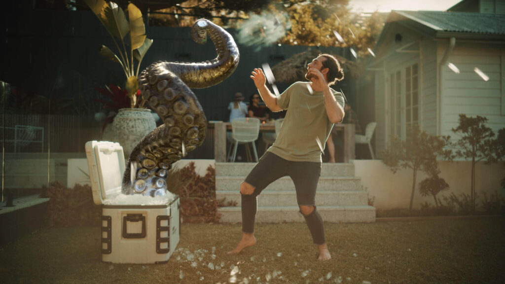 Still from Kraken Black Mojito TVC featuring a tentacle clutching a can of the drink surprising a consumer - VFX animation by VANDAL 